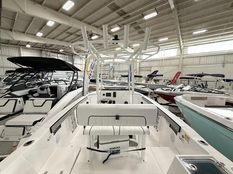 Slide: The Image of 2025 Yamaha Boats 220 FSH Sport in showroom, featuring sleek design and modern amenities. - 5