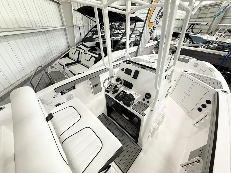 Slide: The Image of 2025 Yamaha Boats 220 FSH Sport interior with white seating and modern controls. - 6