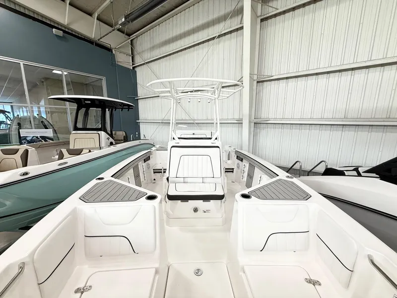 Slide: The Image of 2025 Yamaha Boats 220 FSH Sport in showroom, showcasing sleek interior design. - 7