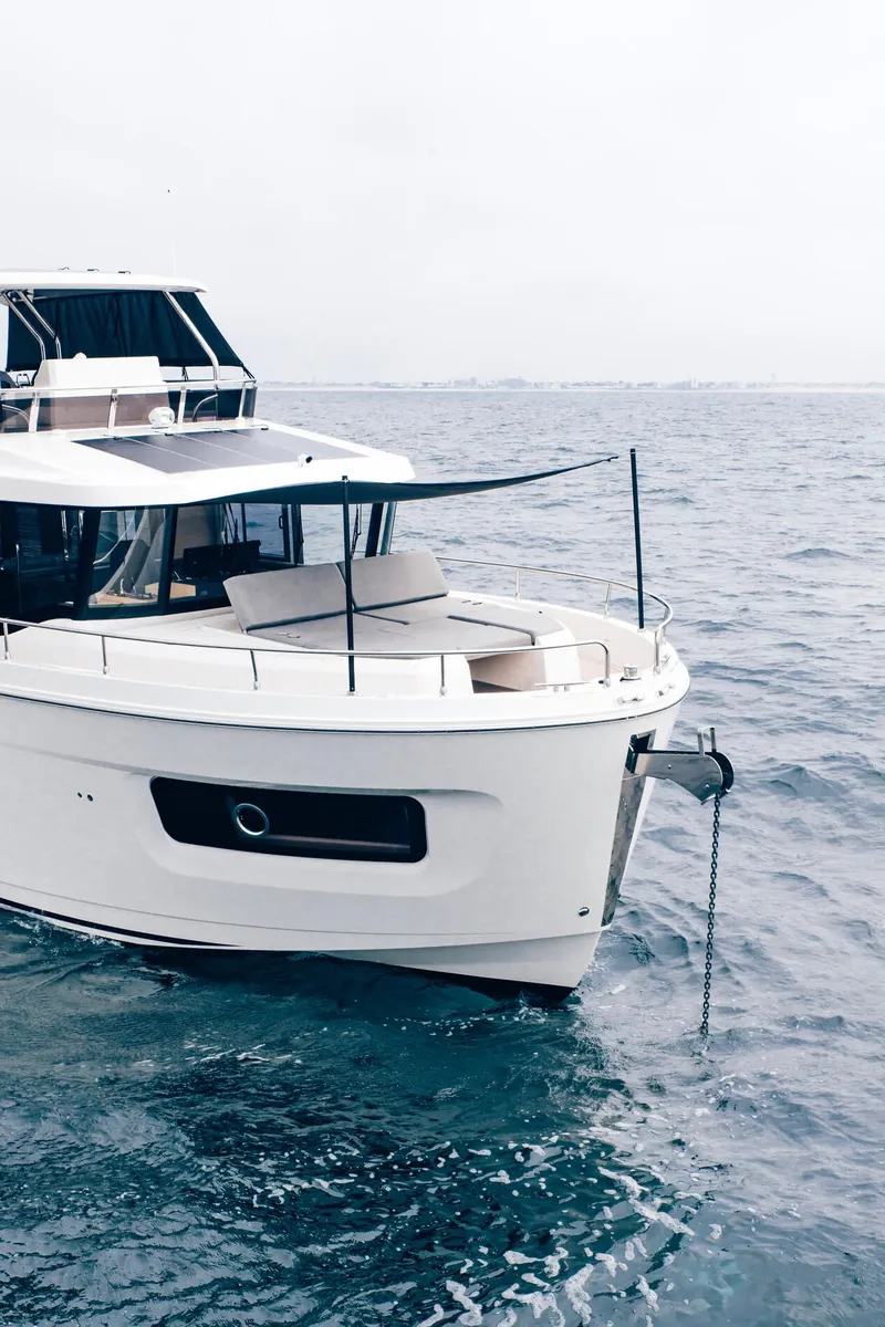 Slide: The Image of 2025 Beneteau Swift Trawler 54 cruising on open sea. - 3