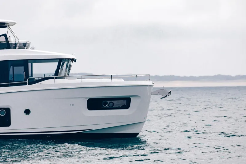 Slide: The Image of 2025 Beneteau Swift Trawler 54 cruising on open water. - 4