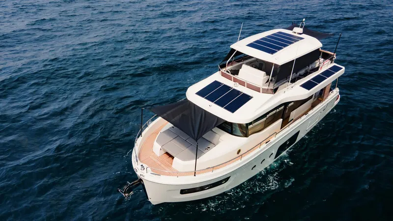Slide: The Image of 2025 Beneteau Swift Trawler 54 with solar panels cruising on open sea. - 7