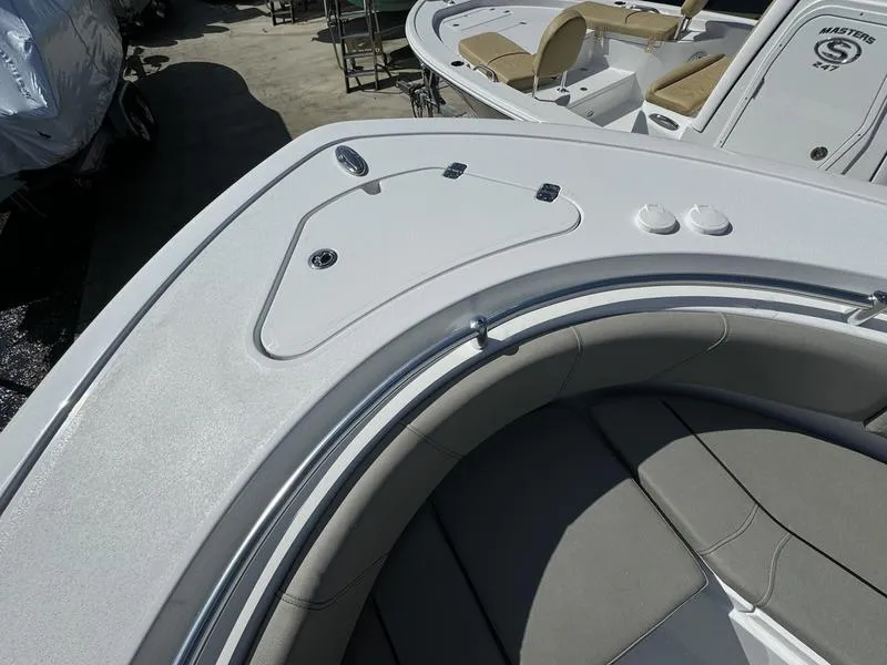 Slide: The Image of 2025 Sportsman Open 232 boat interior with cushioned seating and sleek design. - 11