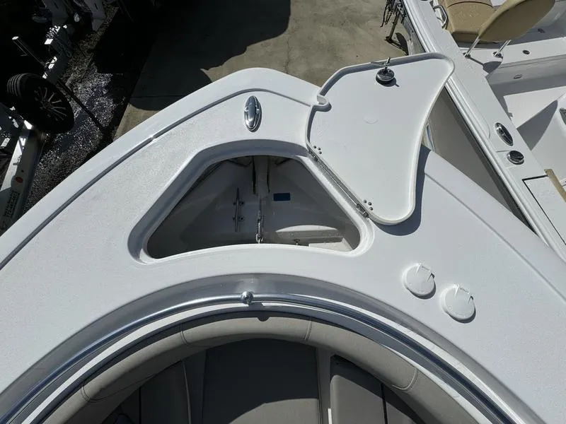 Slide: The Image of 2025 Sportsman Open 232 boat bow with open storage compartment. - 12