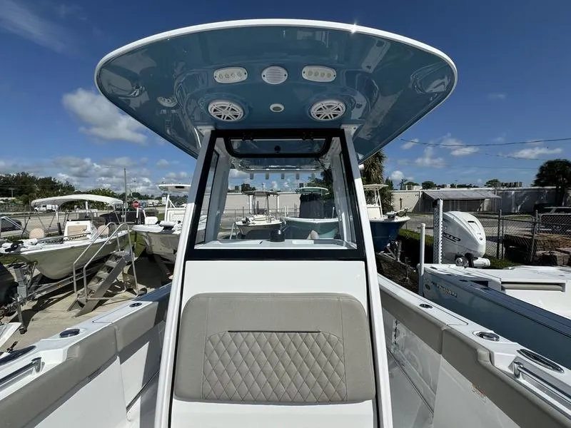Slide: The Image of 2025 Sportsman Open 232 boat, center console, marina background, sunny day. - 14