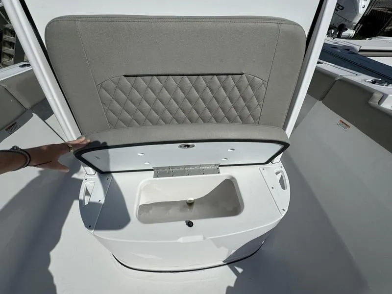 Slide: The Image of 2025 Sportsman Open 232 boat seat with storage compartment open. - 15