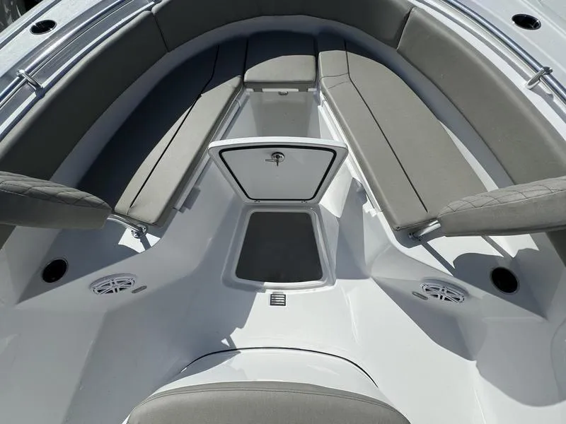 Slide: The Image of 2025 Sportsman Open 232 boat interior with cushioned seating and storage. - 16
