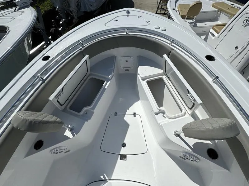 Slide: The Image of 2025 Sportsman Open 232 boat interior with open storage compartments and seating. - 5