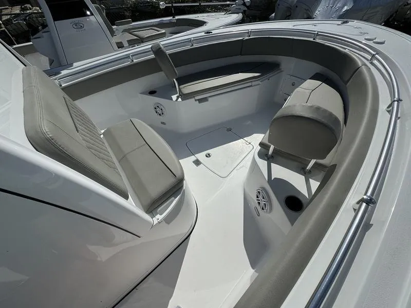 Slide: The Image of 2025 Sportsman Open 232 boat interior with cushioned seating and sleek design. - 6