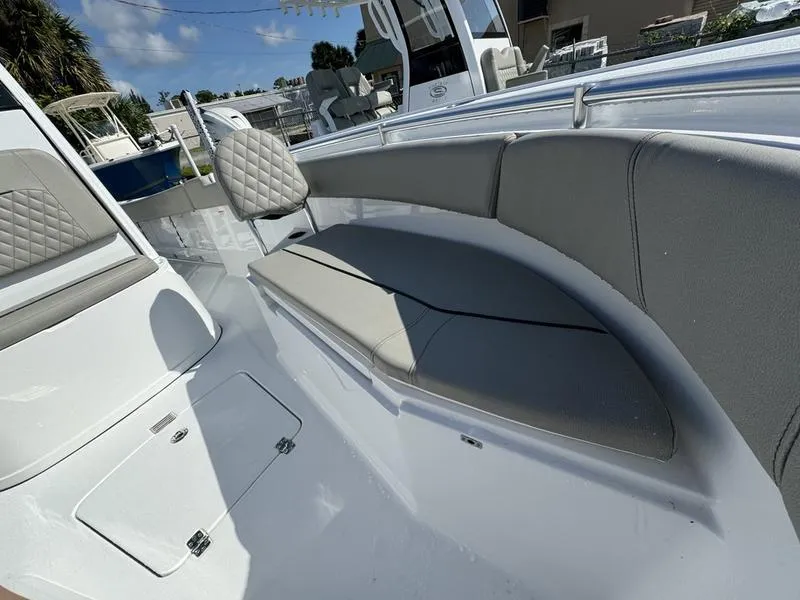 Slide: The Image of 2025 Sportsman Open 232 boat interior with cushioned seating and storage compartments. - 7