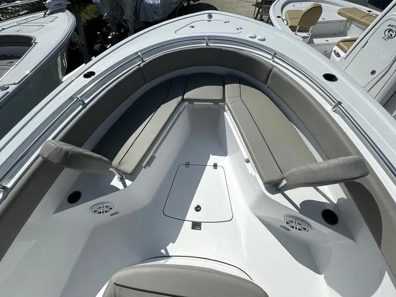Slide: The Image of 2025 Sportsman Open 232 boat interior with cushioned seating and storage compartments. - 8
