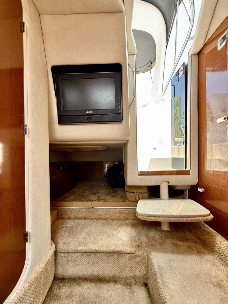 Slide: The Image of Interior of 2010 Sea Ray 280 Sundancer with TV and carpeted steps. - 12