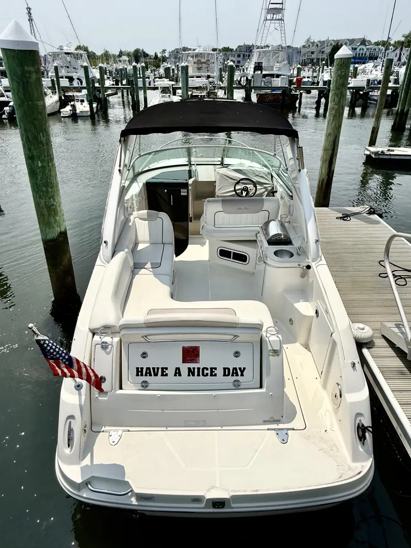 Slide: The Image of 2010 Sea Ray 280 Sundancer docked at marina, featuring "Have a Nice Day" sign. - 13