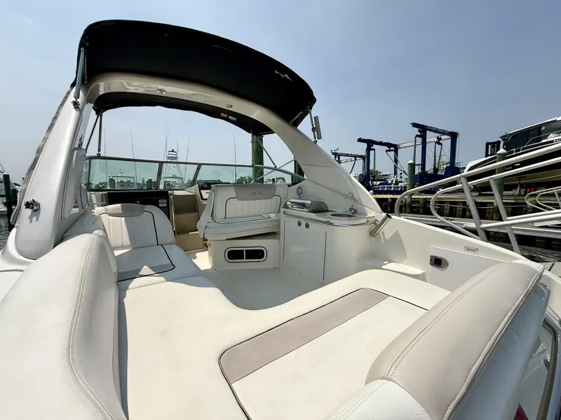 Slide: The Image of 2010 Sea Ray 280 Sundancer boat interior with white seating and canopy. - 4