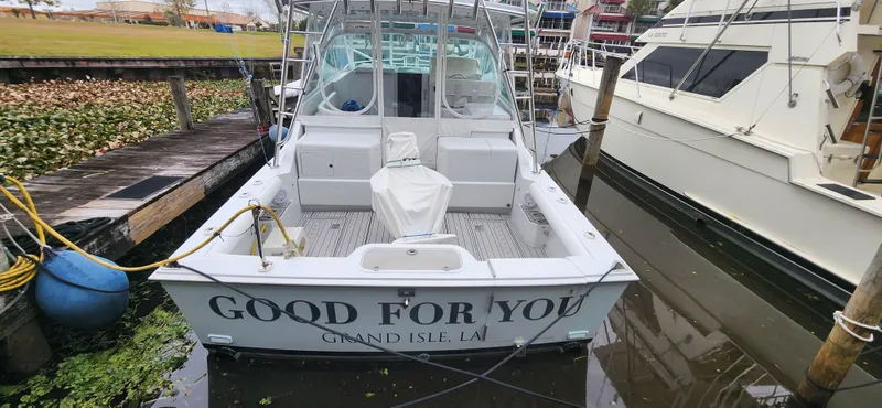 Slide: The Image of 1995 Cabo 35 Express boat docked, named "Good For You," Grand Isle, LA. - 2
