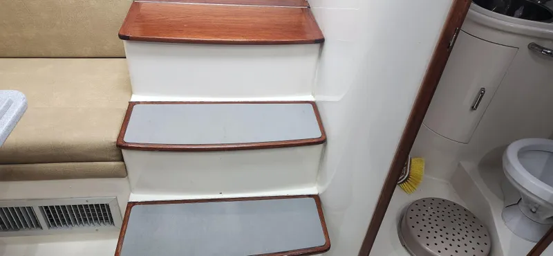 Slide: The Image of Interior of 1995 Cabo 35 Express boat showing stairs and bathroom area. - 31