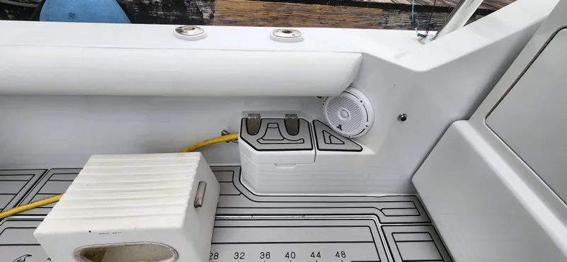 Slide: The Image of 1995 Cabo 35 Express boat interior with speaker and storage compartment. - 42