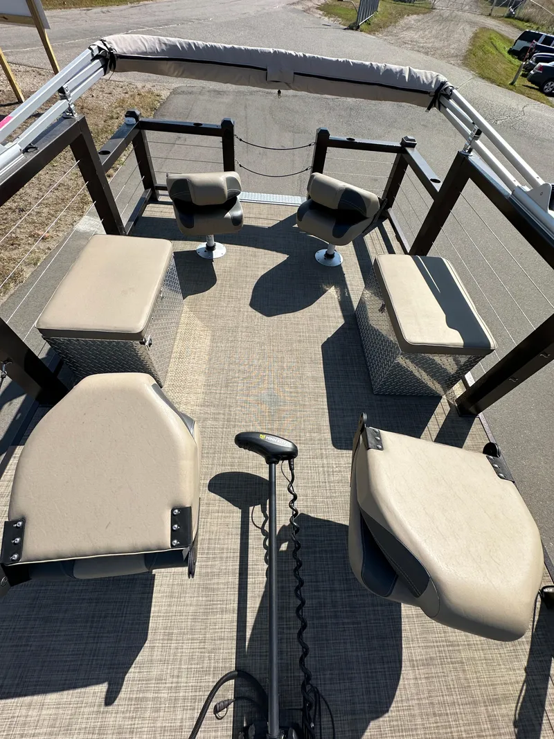 Slide: The Image of 2021 Lake Lounger 13FISH4E boat interior with seating and steering controls. - 5