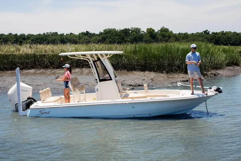 The Image of 2026 Scout 231 XSB boat with two people fishing in a serene waterway. - 0