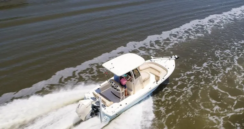 Slide: The Image of 2026 Scout 231 XSB boat cruising on open water, aerial view. - 1