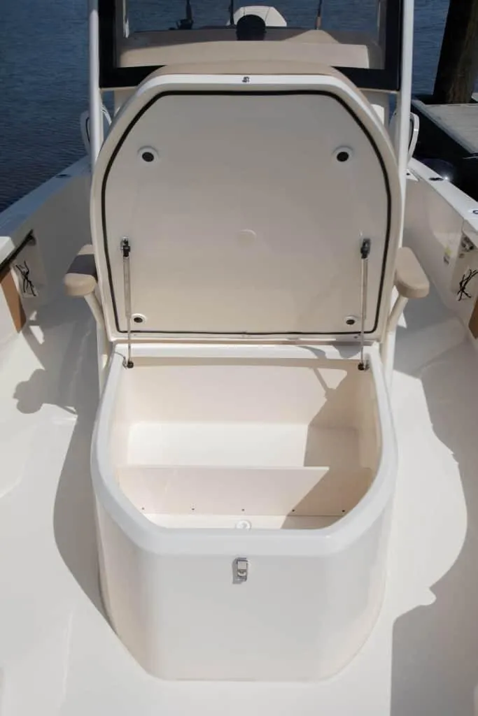 Slide: The Image of 2026 Scout 231 XSB boat storage compartment with open lid, showcasing spacious interior. - 6