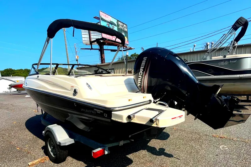 Slide: The Image of 2018 Bayliner 180 Bowrider boat with outboard motor on a trailer. - 2