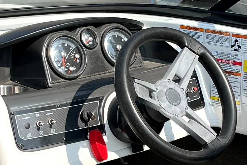 Slide: The Image of Dashboard of a 2018 Bayliner 180 Bowrider boat with steering wheel and gauges. - 4