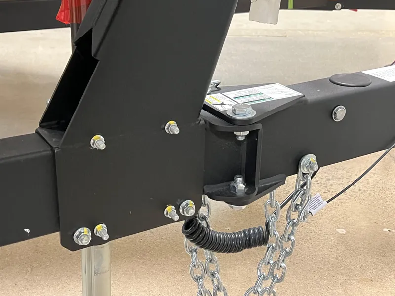 Slide: The Image of Trailer hitch of 2025 Yamaha Boats AR190 with safety chains and bolts. - 13