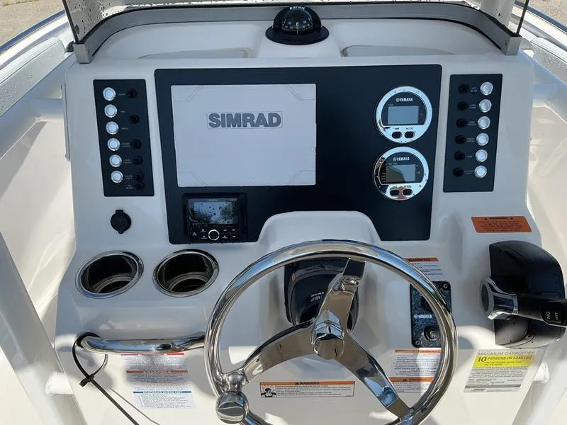 Slide: The Image of Control panel of 2025 Robalo 222 EX boat with Simrad display and Yamaha gauges. - 11