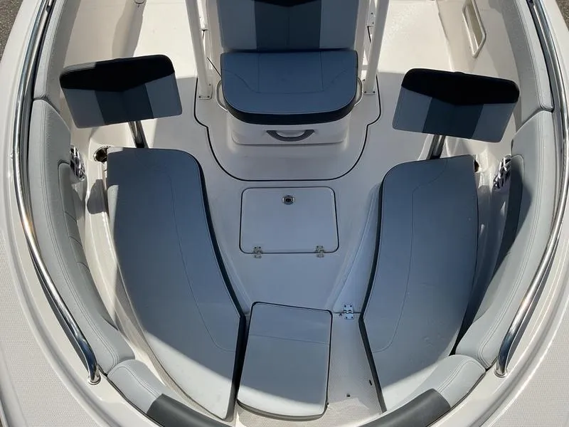 Slide: The Image of 2025 Robalo 222 EX boat interior with cushioned seating and storage compartments. - 13