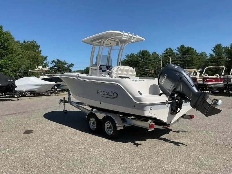 Slide: The Image of 2025 Robalo 222 EX boat on trailer, featuring Yamaha outboard motor, parked outdoors. - 4