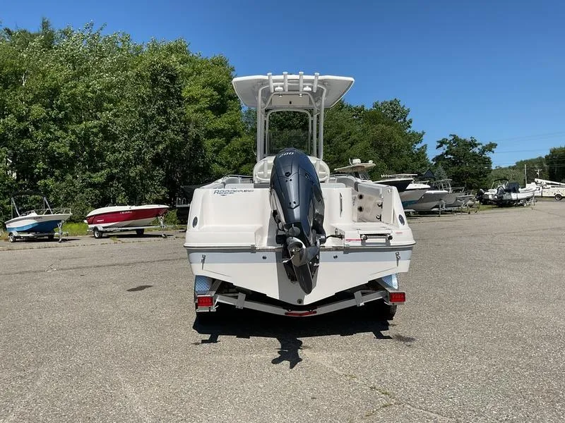 Slide: The Image of 2025 Robalo 222 EX boat with outboard motor, parked on a sunny day. - 5