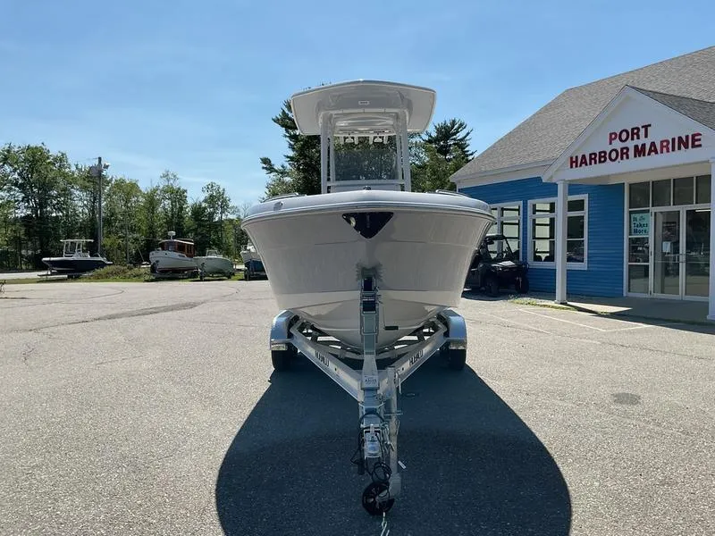 Slide: The Image of 2025 Robalo 222 EX boat on trailer at Port Harbor Marine dealership. - 6