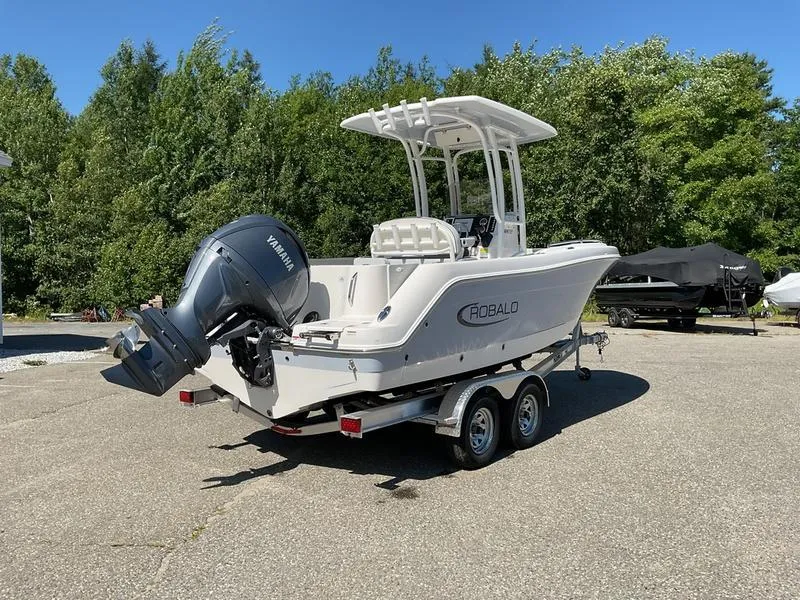 Slide: The Image of 2025 Robalo 222 EX boat on trailer with Yamaha outboard, parked outdoors. - 8
