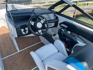 Slide: The Image of 2017 Nautique Super Air Nautique G23 boat docked by a lake. - 7