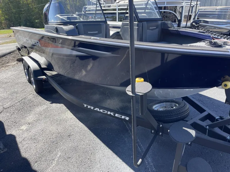 Slide: The Image of 2025 Tracker Targa V-19 Combo boat on trailer, parked outdoors. - 2
