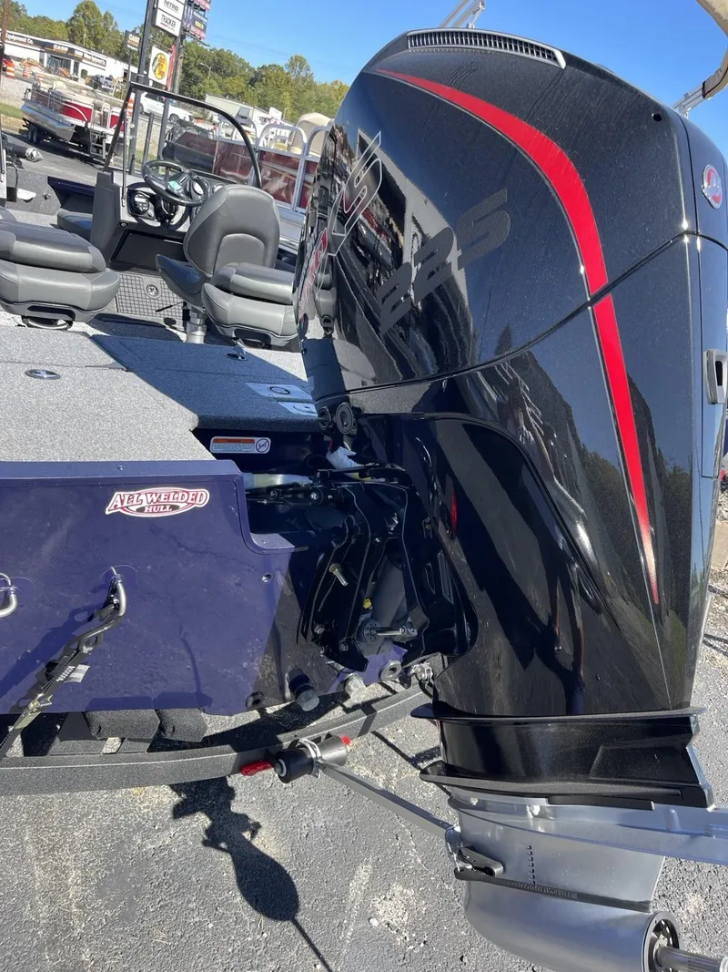 Slide: The Image of 2025 Tracker Targa V-19 Combo boat with sleek black and red motor design. - 3