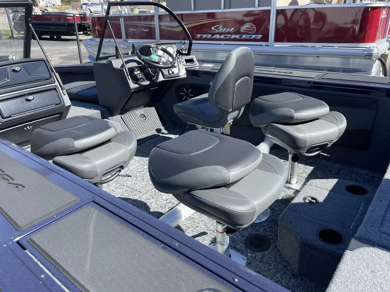Slide: The Image of 2025 Tracker Targa V-19 Combo boat interior with four cushioned seats and steering console. - 6