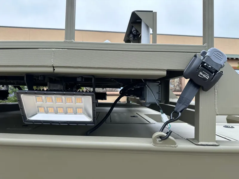 Slide: The Image of 2025 Tracker Grizzly 2072 CC Sportsman boat with mounted LED light and secure strap. - 5