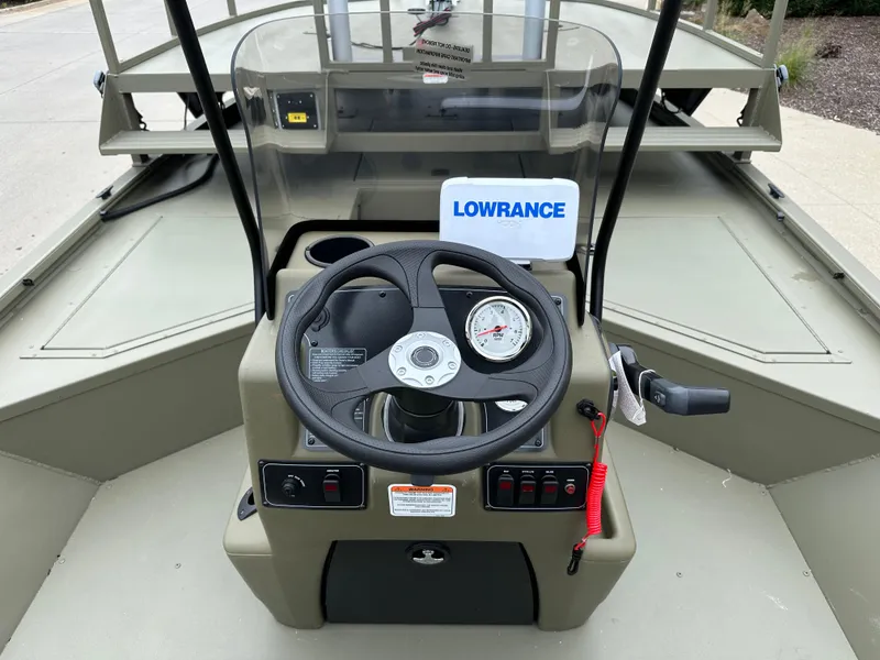 Slide: The Image of 2025 Tracker Grizzly 2072 CC Sportsman boat dashboard with steering wheel and Lowrance device. - 8