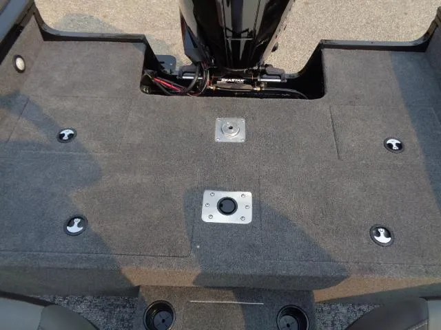 Slide: The Image of 2025 Tracker Targa V-19 WT boat deck with motor mount and storage compartments. - 12