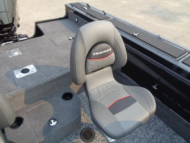 Slide: The Image of 2025 Tracker Targa V-19 WT boat seat, gray with red accents, on carpeted deck. - 13