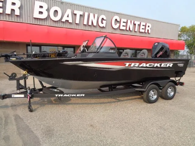 Slide: The Image of 2025 Tracker Targa V-19 WT boat at dealership, black with red accents. - 2
