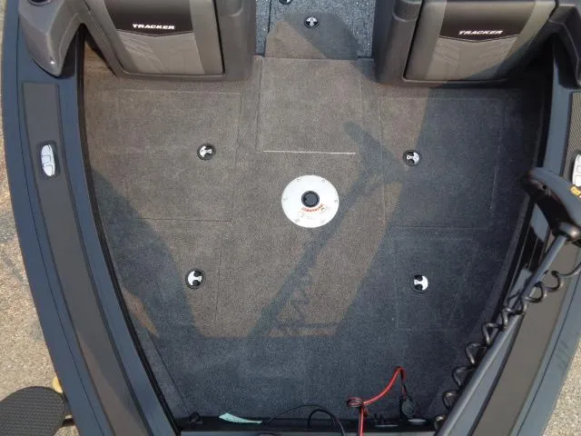 Slide: The Image of 2025 Tracker Targa V-19 WT boat interior with carpeted deck and seating. - 8