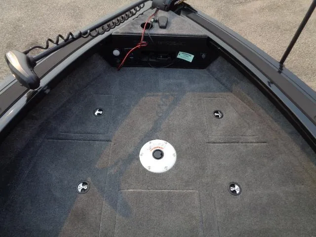 Slide: The Image of 2025 Tracker Targa V-19 WT boat interior with carpeted deck and mounting points. - 9