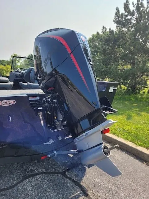 Slide: The Image of 2025 Tracker Targa V-19 Combo boat with powerful outboard motor in a sunny outdoor setting. - 2