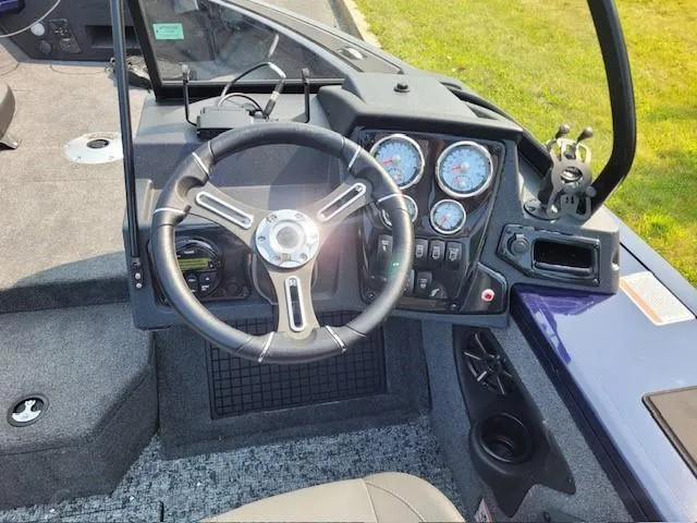 Slide: The Image of 2025 Tracker Targa V-19 Combo boat dashboard with steering wheel and gauges. - 3