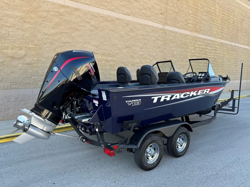 Slide: The Image of 2025 Tracker Targa V-19 Combo boat on trailer, parked outdoors. - 2