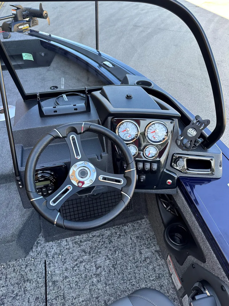 Slide: The Image of 2025 Tracker Targa V-19 Combo boat dashboard with steering wheel and gauges. - 6