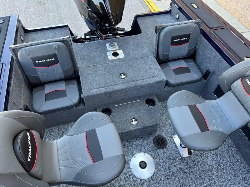 Slide: The Image of 2025 Tracker Targa V-19 Combo boat interior with four gray and red seats. - 7